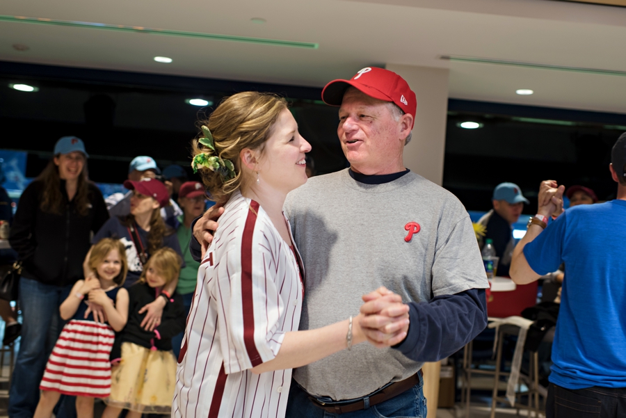 A bride dances with her father to Take me out to the ball game during their Phillies game reception.